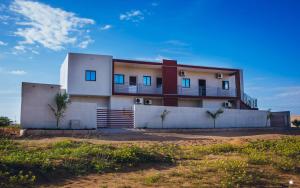 a house with a balcony on top of it at Residencial Biva in Namibe