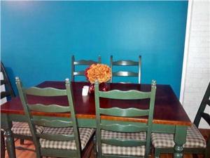 a dining room table with chairs and a blue wall at Summer Sea Vacation Rental in South Yarmouth