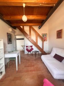a living room with a couch and a table at La Fratta Art - House in Marsciano