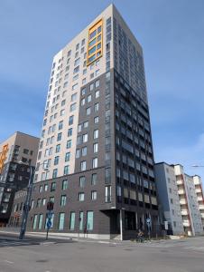 a tall building on the corner of a street at Foliate Living Varpu in Jyväskylä
