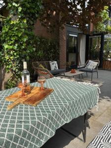 a table with a bottle of wine on top of it at De groene salon in Broek in Waterland