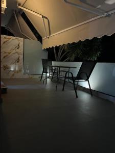 a room with a table and two chairs in it at Spiros Rooms in Kastrosikia