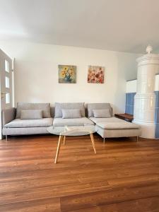 a living room with a couch and a coffee table at FEWO Studio7 in Vorderelsenwang +44 photos