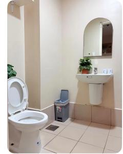 a bathroom with a toilet and a sink at Sunvida Tower Across SM Cebu CITY VIEW in Cebu City