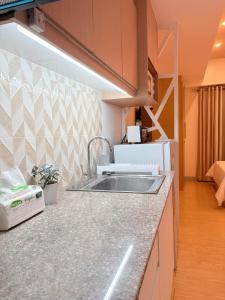 a kitchen with a sink and a counter top at Sunvida Tower Across SM Cebu CITY VIEW in Cebu City