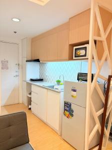 a kitchen with a refrigerator and a counter top at Sunvida Tower Across SM Cebu CITY VIEW in Cebu City +20 photos