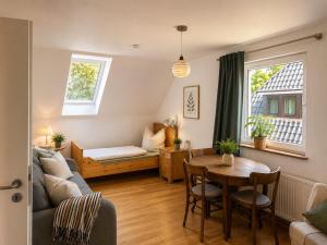a living room with a couch and a table at Amrum Family Hideaway-Grosse Wohnung in Norddorf für bis zu 6 Personen in Norddorf