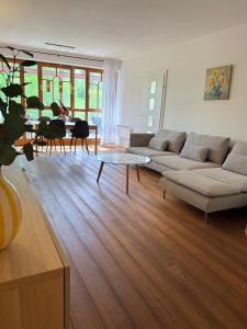 a living room with a couch and a table at FEWO Studio7 in Vorderelsenwang