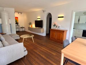a living room with a couch and a table at FEWO Studio7 in Vorderelsenwang