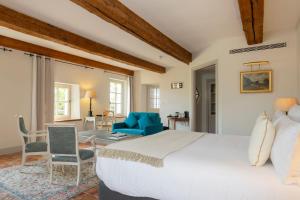 a bedroom with a large bed and a living room at Hôtel - Restaurant & Spa La Magdeleine - Mathias Dandine in Gémenos +267 photos