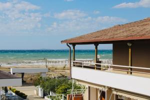 a view of the ocean from the balcony of a building at ANORA Mare Suites in Orikum