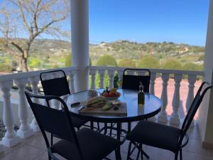 a table with a plate of fruit on a balcony at Letymvou Terrace in Letimbou
