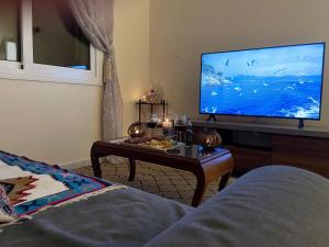 a living room with a tv and a coffee table at Letymvou Terrace in Letimbou