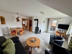 a living room with a couch and a table at Ferienwohnung Matschak OG links in Fehmarn