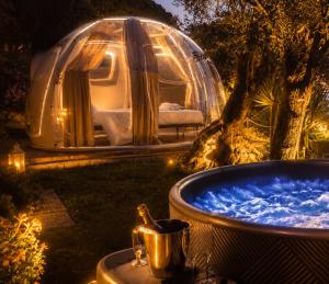 a large tub with a tent in the background at Counting Stars - Private Luxury Retreat for Two in Recco
