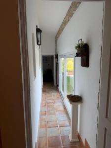 a hallway with white walls and a tile floor at Quinta do Passal in Coimbra