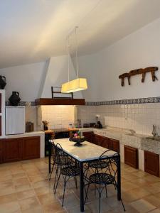 a kitchen with a table and chairs in it at Quinta do Passal in Coimbra