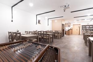 a restaurant with tables and chairs and a dining room at Vinařství Herůfek in Zaječí