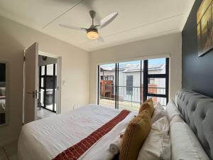 a bedroom with a bed and a ceiling fan at Onyx Oasis in Ballito