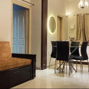 a dining room with black chairs and a table at 22nd Weekend Stays in Bhīm Tāl