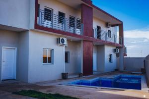 a apartment building with a balcony and a building at Residencial Biva in Namibe