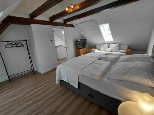 a bedroom with a large bed in a room at s' Kännele Ferienwohnungen in Mudau