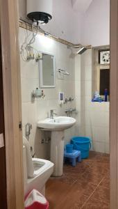 a bathroom with a sink and a toilet and a mirror at 22nd Weekend Stays in Bhīm Tāl +26 photos