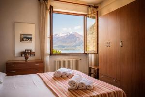 a bedroom with a bed with towels on it at Apartment Alex 1 in Domaso in Domaso +18 photos