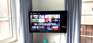 a flat screen tv hanging on a wall at Ferienwohnungen Matschak OG rechts in Fehmarn