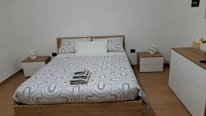 a bedroom with a bed with shoes on it at Valle degli Alburni in Postiglione