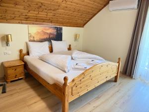 a bedroom with a large bed with a painting on the wall at Haus Seerose in Seeboden