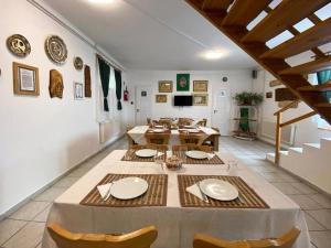 a large dining room with a table and chairs at Franc Llagami - Rooms in Vecsés +15 photos