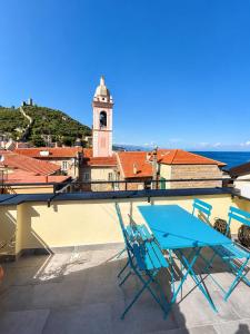 a couple of chairs and a table on a roof at Ca' Du Marchin, Noli. in Noli