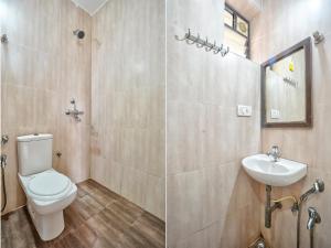 a bathroom with a toilet and a sink at Hotel Salty Waves Baga in Baga +29 photos