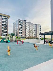a playground with benches and tables and buildings at Ilo2stayAirbnb 1BR Luna in Iloilo City