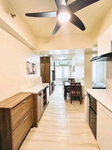 a kitchen with a ceiling fan and a dining room at Ilo2stayAirbnb 1BR Luna in Iloilo City