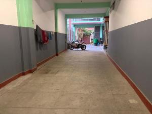 a hallway with a motorcycle parked in a building at Shree Muktinath Hotel in Pokhara +7 photos