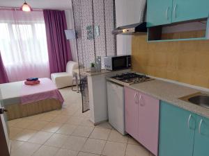 a kitchen with a sink and a stove top oven at Geo Studios in Saturn +30 photos