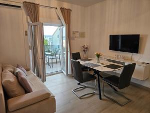 a living room with a table and a couch at Apartments Bilopavlović in Kaštela