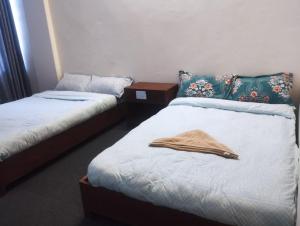 two beds in a room with towels on them at Shree Muktinath Hotel in Pokhara