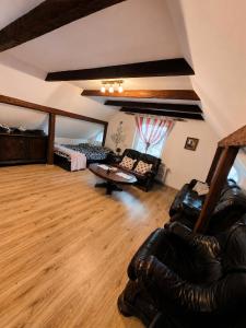 a large living room with a couch and a chair at Chill House Lipowo Mazury in Lipowo