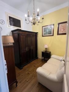 a living room with a white couch and a chandelier at Family Macedo in Lisbon +38 photos