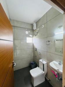 a bathroom with a toilet and a sink at Pine Trees Home Holidays in Vagamon +36 photos