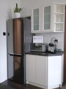 a kitchen with a refrigerator and a microwave at Studio Szczawienko 2 in Wałbrzych +8 photos