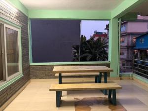 a bench in a room with a large window at Shree Muktinath Hotel in Pokhara