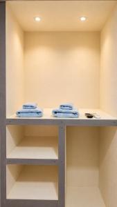 a shelf with folded blue towels on it at Hotel Premier in Escuintla