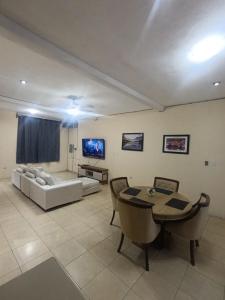 a living room with a table and a couch at Hotel Premier in Escuintla