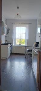 a large kitchen with a table and a window at Studio Szczawienko 2 in Wałbrzych