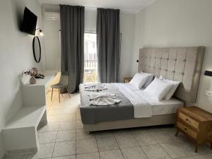 a bedroom with a king sized bed in a room at Prokopis Studios in Laganas +20 photos