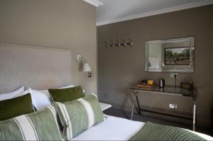 a hotel room with a bed and a mirror at The George at Backwell in Bristol